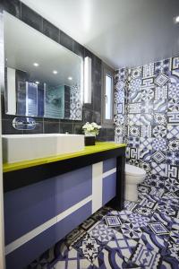 a bathroom with a sink and a toilet and a mirror at A3_Aplotaria Architect's Apartment in Chios +54 photos