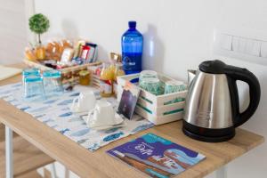 a kitchen table with a tea kettle on it at LANTERNA DEL DELTA Guest House in Porto Tolle