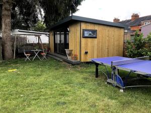 a ping pong table in front of a tiny house at Henley Garden Studio in Henley on Thames