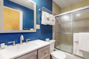 a bathroom with a toilet and a sink and a shower at Bee Branch 44 in Sugar Mountain +10 photos