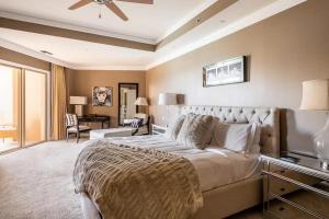 a large bedroom with a large bed and a desk at Ocean View Residence 304 located at The Ritz-Carlton in Upper Land