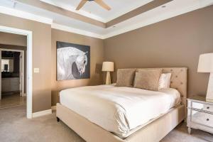 a bedroom with a bed and a picture of a horse at Ocean View Residence 304 located at The Ritz-Carlton in Upper Land