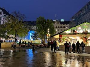 a group of people walking around a christmas market at Studio flat in the center of Budapest in Budapest