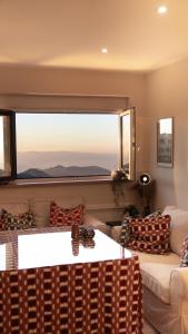 a living room with a couch and a large window at Luxury and newly refurbished 3 bedroom apartment next to the slopes including indoor parking in Sierra Nevada