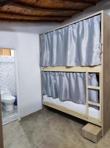 a bunk bed in a room with a toilet at Hostal Casablanca in San Gil