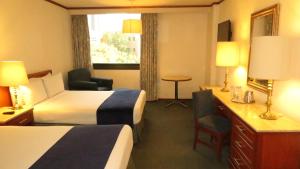 Postel nebo postele na pokoji v ubytování Hotel Bristol