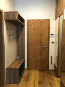 a room with a wooden door in a room at Wellness Apartmán Kvilda in Kvilda