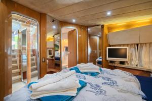 a bedroom with a bed with towels on it at Luxury Yacht - Lex of the Seas in Split