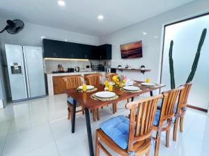 a kitchen and dining room with a wooden table and chairs at Deja View in Jimbaran