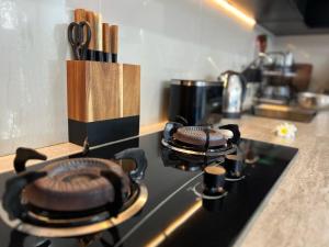 a stove top with two pots on top of it at Deja View in Jimbaran