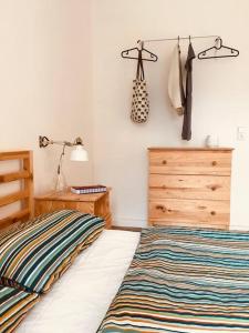 a bedroom with a bed and a dresser and a closet at Peenekoje in Peenemünde