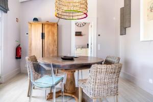 a dining room with a wooden table and chairs at Boutique house with Pateo in Sintra