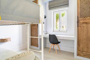 a bedroom with a bunk bed and a chair at Boutique house with Pateo in Sintra