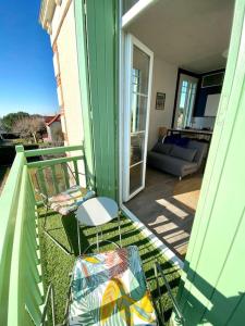 a patio with two chairs and a couch on a balcony at Studio lumineux vue mer et plage avec balcon in Saint-Palais-sur-Mer