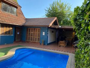 a house with a swimming pool and a patio at Maktub Costanera - Hostal Boutique in Santiago