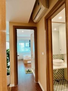 a hallway with a door leading to a bedroom at Muong Thanh Son Tra Apartment Seaview Da Nang in Da Nang