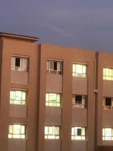an apartment building with its lights on at night at برنس in Marsa Matruh