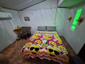a bedroom with a bed with a hello kitty blanket at บ้านสวน สระแก้ว รีสอร์ท 