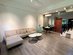 a living room with a couch and a table at 9 Tan Yuan Homestay in Jiaoxi