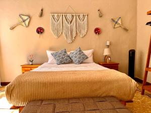 a bedroom with a large bed with pillows on it at Bokatrip El Llano in Oaxaca City