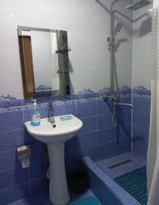 a bathroom with a sink and a shower with a mirror at Apartment near the airport - Квартира около аэропорта in Dushanbe