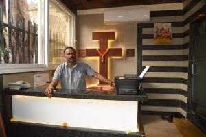 a man standing at a counter in a kitchen at Hotel Triton - Near US Embassy in Mumbai