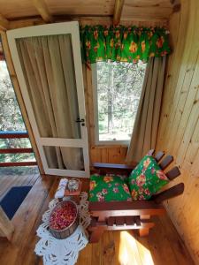 a room with a door and a couch and a window at Chalé Refúgio das Águas in Urupema +24 photos