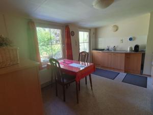 a kitchen with a red table and chairs in a room at Ferienwohnung am Wald in Biesenthal