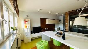a kitchen with a white counter and green accents at Smart Apartment Warsaw in Warsaw
