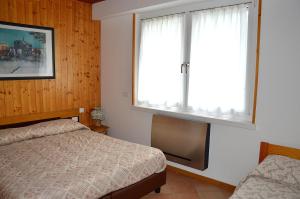 Кровать или кровати в номере Appartamenti Vacanze Casa Marilleva