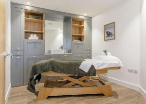 a bathroom with a bed and a sink in a room at Windmill Retreat in Middlezoy