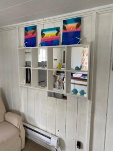 a living room with white shelves and a couch at Beach Cottage on North Beach in Hampton