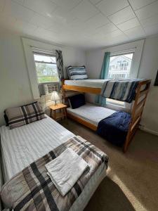 a bedroom with two bunk beds and a table at Beach Cottage on North Beach in Hampton