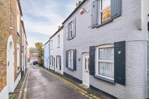 an alley with white buildings on a street at Host & Stay - Ethelbert Cottage in Broadstairs