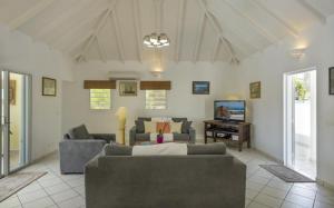 a living room with two couches and a tv at Saint Barth Villa 3 in Saint-Jean