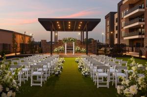 an outdoor wedding with white chairs and white flowers at SpringHill Suites by Marriott Franklin Mint in Franklin