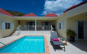 a villa with a swimming pool and a house at Saint Barth Villa 3 in Saint-Jean