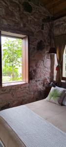 um quarto com uma cama grande e uma janela em Oforasteiro em Mucugê