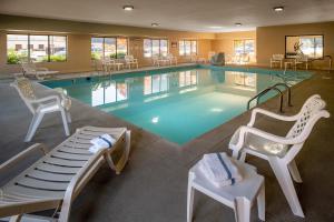a large swimming pool with chairs at Comfort Suites Prestonsburg West in Prestonsburg