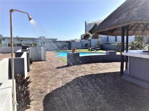 a patio with an umbrella and a swimming pool at Nomads Nook 15 in Ramsgate