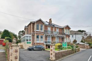 a house with a car parked in front of it at Finest Retreats - Atherfield Apartments No 8 - Roof Tops in Paignton