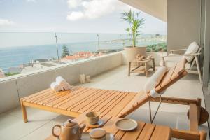 a balcony with a table and a view of the ocean at EVOLUTION Cascais-Estoril Hotel in Estoril