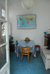 a table in a living room with a map on the wall at Lunfardo Boquense in Buenos Aires