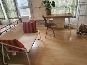 a living room with a couch and chairs and a desk at BluepointPH in Abbey Wood