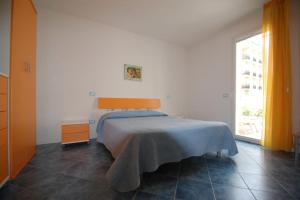 a bedroom with a bed and a large window at Souvenir 6 in Gabicce Mare