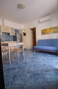 a living room with a blue couch and a table at Souvenir 6 in Gabicce Mare +32 photos
