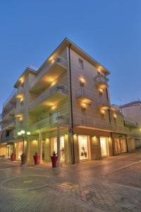 a large building on a city street at night at Souvenir 6 in Gabicce Mare