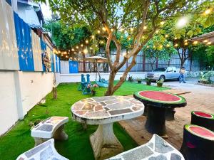 a garden with a table and a tree with lights at Heartbeat Crypto Jomtien 05 in Jomtien Beach