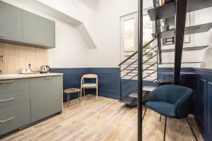 une cuisine avec des murs bleus et un escalier en colimaçon dans l'établissement District Nation, à Paris