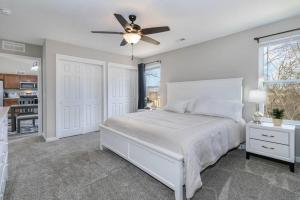 a bedroom with a white bed and a ceiling fan at Home among the Nook in Hamilton Ohio in Hamilton +30 photos